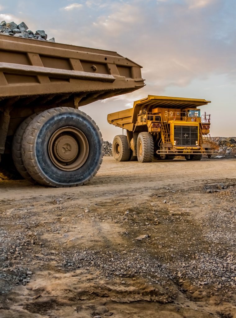 A vertical shot of dump trucks transporting Platinum ore for processing
