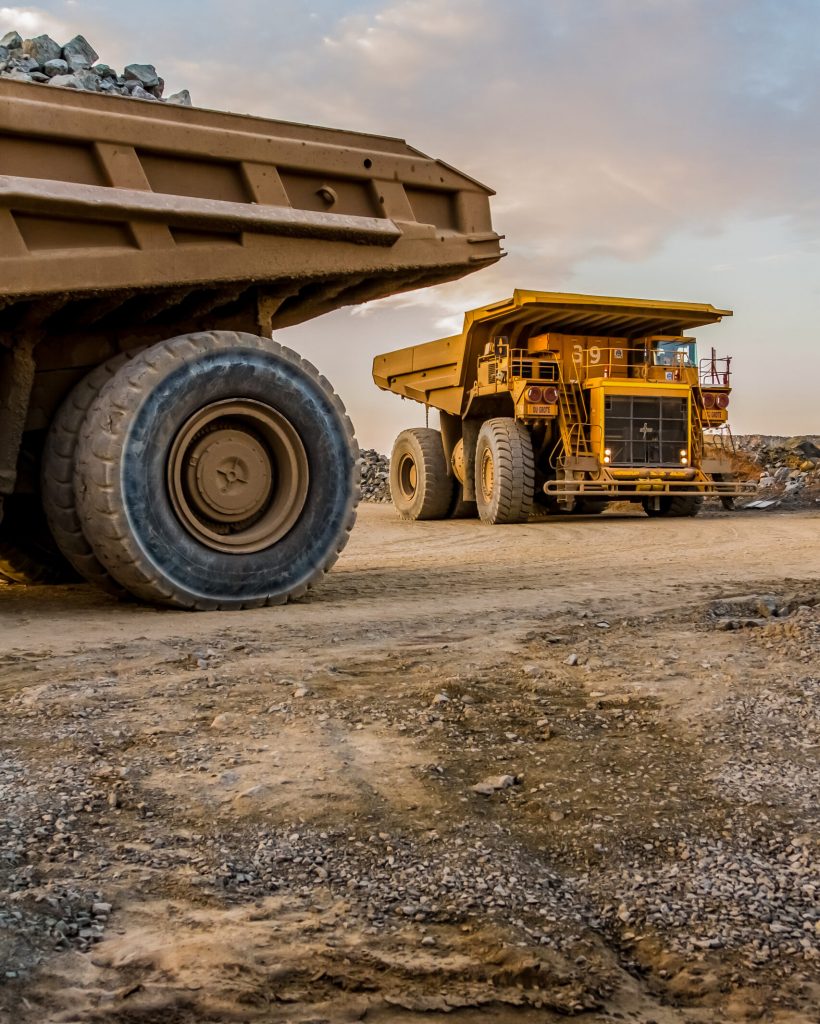 A vertical shot of dump trucks transporting Platinum ore for processing